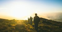 Young people hiking in hills.